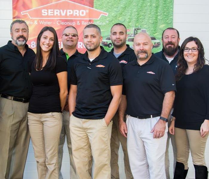 SERVPRO staff in tan pants and black shirts